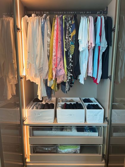 A full view of a wardrobe section, showing how hanging clothes, shelf bins, and drawers can be combined for a complete storage solution.