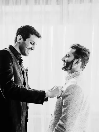 A brother-in-law helping the groom with his final touches. These are the heartwarming, behind-the-scenes moments that I love to capture.
