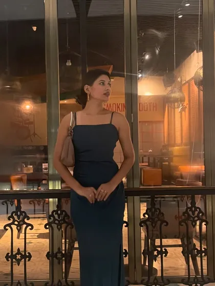 A simple but elegant look for an evening out. This teal slip dress with a side slit is a versatile piece, styled here with a messy bun and delicate gold earrings.