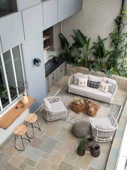 In a city like Mumbai, an outdoor space is a true luxury. This aerial view shows how I transformed a 500 sq. ft. deck into a sprawling urban oasis, complete with a mobile bar, lush planters, and comfortable seating, making it the heart of the home for social gatherings.