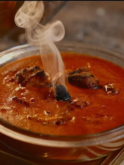 The smoky aroma of my Murg Angara Korma is captured perfectly here. The steam rising from the charcoal piece infuses the rich, red gravy with a distinct, barbecue-like flavor.