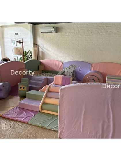 A pastel-colored soft play area provides a safe and fun zone for the youngest party guests to tumble and play.