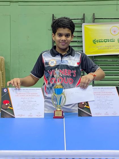 Sharvil K with his trophy and certificates for his double silver medal performance at the Mysore state ranking.