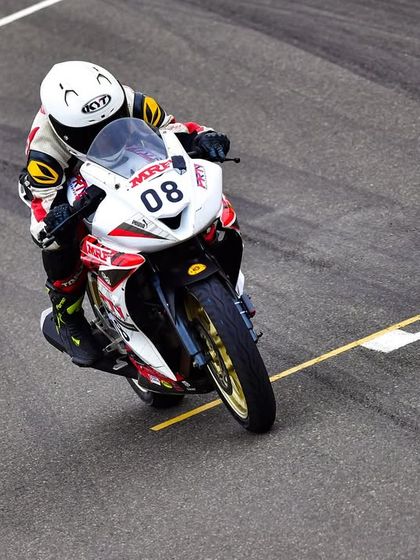 An aerial view of Meghana on the main straight, showcasing her form and the professional environment of the national championship.