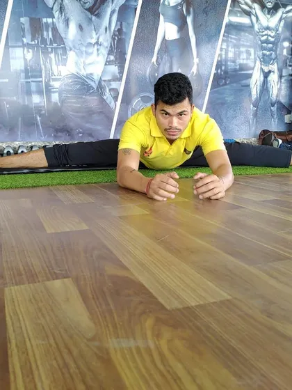 Flexibility is just as important as strength. Here I am demonstrating a full front split, a result of consistent stretching and mobility work that I incorporate into my training plans.
