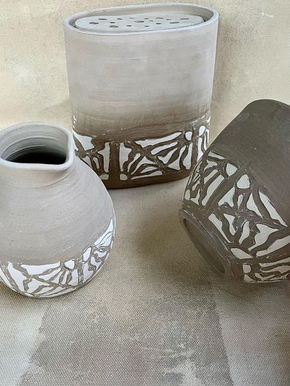 Work-in-progress from a student's Japanese-themed tableware collection, featuring intricate slip-trailing designs.