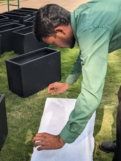 A close-up of a team member unboxing one of the planters. You can see the protective wrapping we use to prevent any scratches or damage during transit.
