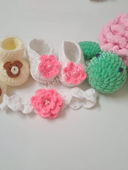 A custom baby gift hamper showing a plush rose turtle, bear-themed booties, and a floral headband. I can mix and match items to create your perfect gift.