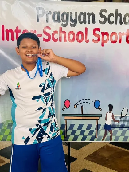 The joy of victory! Yashbeer Singh celebrates with his silver medal after a fantastic performance at the Badminton Inter-School Sports Meet. Team events like these build both skill and camaraderie.