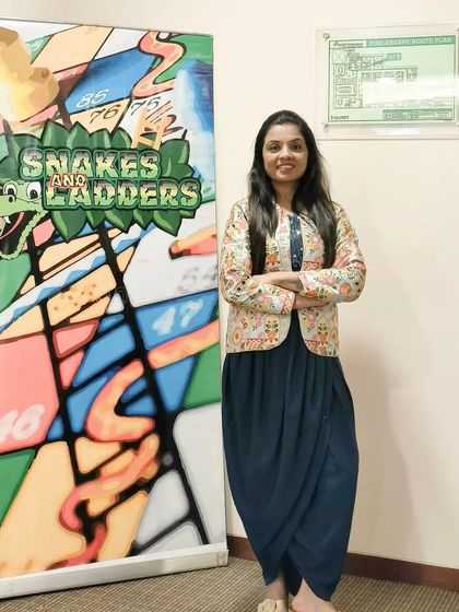 Standing proudly next to the custom Snakes and Ladders setup for the ICICI Venture event. I can help plan and organize all aspects of your event, including unique game stalls and activities.