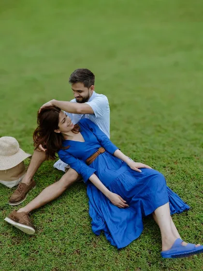 A playful and relaxed moment captured in the open fields near Bangalore. This image showcases a casual and fun pre-wedding session, where the couple's joy is the main focus against a serene, natural backdrop.