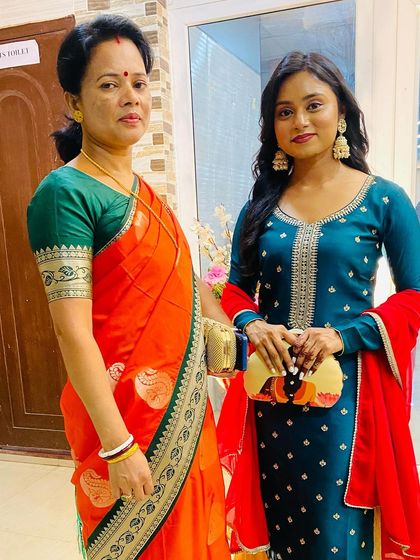 A beautiful moment captured. Our abstract portrait clutch adds a pop of color and art to this elegant teal ethnic suit.