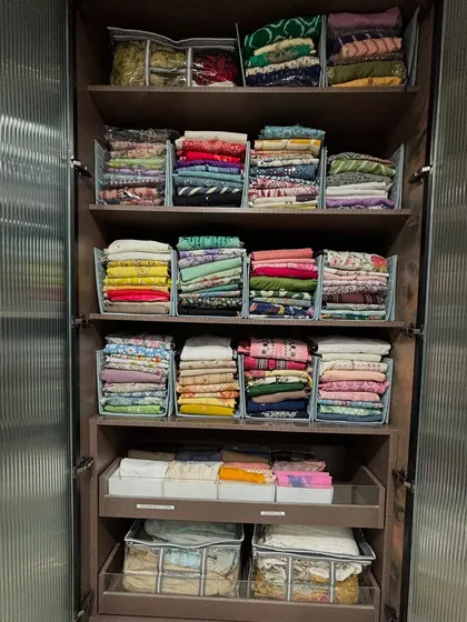 A full wardrobe dedicated to folded Indian wear. Using shelf dividers creates a library of textiles, where each piece is easy to identify and access.