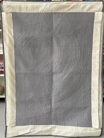 The back of the Fibonacci quilt, where the spiral quilting creates a stunning visual effect on its own.
