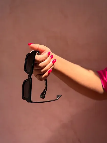 A still shot from the video, capturing the vibrant hot pink nails against a matching pink background. The color is just so full of life and energy.