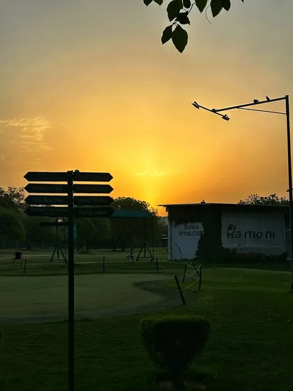 The golden hour light paints the sky over our Fitting Studio and practice green.