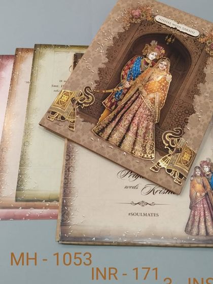 This card features a beautiful illustration of Radha and Krishna, with smaller elephant motifs adding to the traditional feel. The textured paper and warm tones make it a lovely choice.