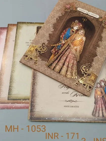 This card features a beautiful illustration of Radha and Krishna, with smaller elephant motifs adding to the traditional feel. The textured paper and warm tones make it a lovely choice.