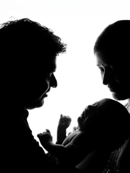 Sometimes, a silhouette tells the most powerful story. This artistic portrait captures the shape of your new family, a timeless image of love and connection against a simple, clean background.