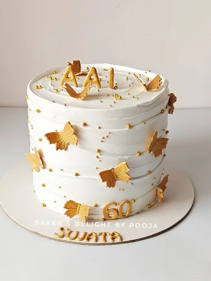 "AAI" means "MOM," and this cake was for her 60th birthday. The elegant white and gold design with delicate butterflies was a symbol of her grace and strength. A milestone this special deserves a beautiful, edible memory.