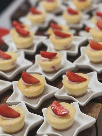 Mini strawberry cheesecakes served on star-shaped plates. The presentation is playful yet elegant, perfect for adding a touch of whimsy to a dessert table.