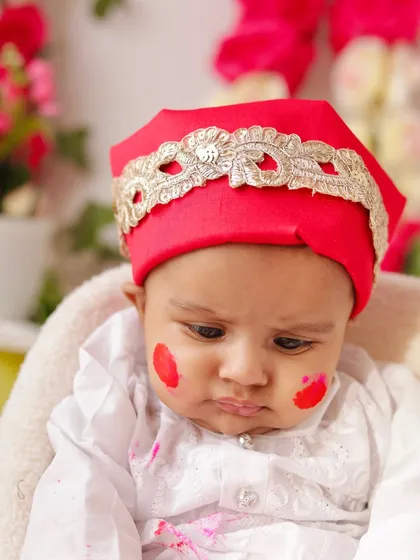 A close-up from our Holi shoot, showing a baby with a little smudge of pink color on his cheek. All colors used are non-toxic and safe for sensitive skin.