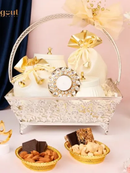 The Samruddhi Diwali Gift Hamper is a complete festive package. It includes nutty delights, chocolates, bliss bars, and a diya, all beautifully arranged in a silver basket to help you gift joy and share smiles.