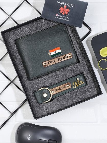 A green leather wallet and keychain set, personalized with an Indian flag and 'Mr.' charms.