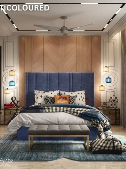 A multicoloured bedroom design that is both playful and sophisticated. The deep blue headboard, wooden accent wall, and unique pendant lights create a vibrant and stylish space for a child or teen.