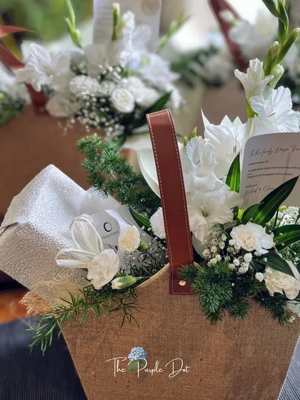 Even bulk orders should feel personal. Here, a series of thank-you hampers, each with a consistent style of fresh white florals and natural jute, demonstrates how I maintain an artisanal touch at scale for team and client gifting.