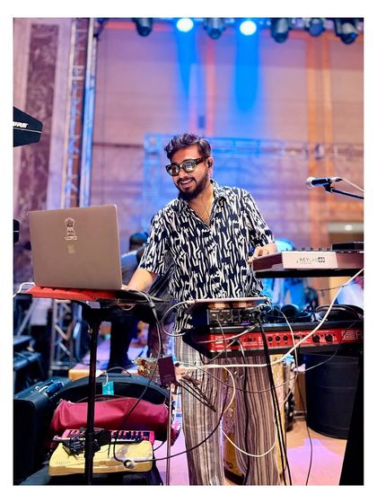 Our keyboardist at his station, surrounded by the tech that helps create our unique sound.