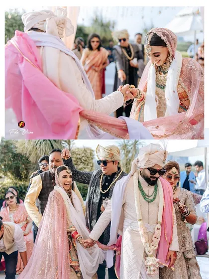 The couple taking their pheras, a significant ritual in a Hindu wedding, captured with a focus on their joined hands and joyful expressions.