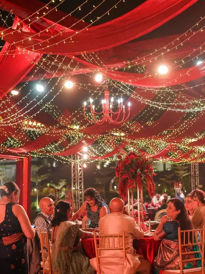 We believe a reception should feel like a galaxy of joy. For this night, we draped the sky in rich red fabric and a constellation of fairy lights, creating a warm, vibrant space where guests could share laughter and make memories under the stars.