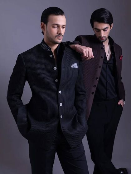 A closer, more intimate shot of the two Bandhgala looks. The focus is on the texture of the fabric and the sharp tailoring that defines these ensembles.