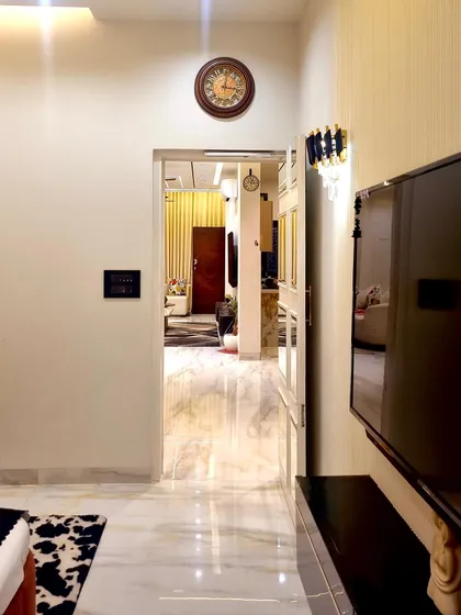 A view from the bedroom looking out into the hallway, showing the seamless flow between different spaces in the home. The design maintains a consistent feel of modern elegance.