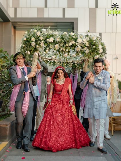 The bride's grand entrance under a beautiful 'phoolon ki chaadar' held by her brothers, a timeless tradition we love to orchestrate.