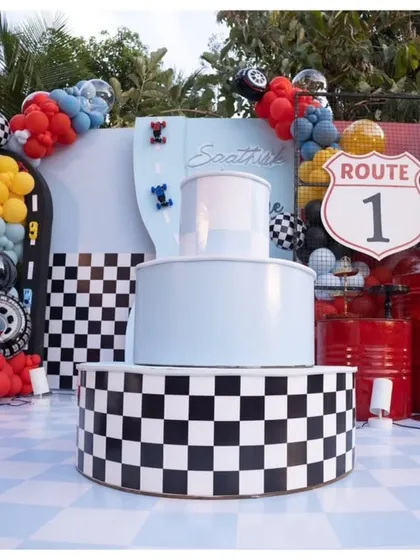 The cake display for the "Fast One" birthday party. The three-tiered stand is decorated with a checkered pattern to look like a winner's podium.