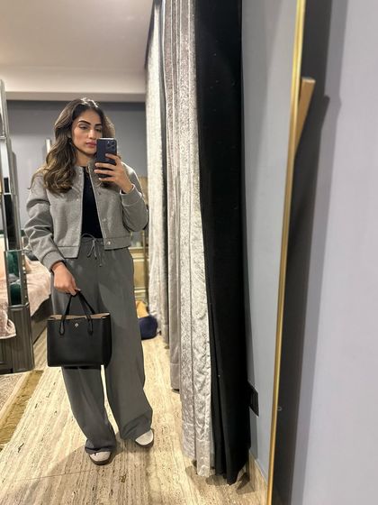 A monochrome grey outfit with a bomber jacket and wide-leg pants.