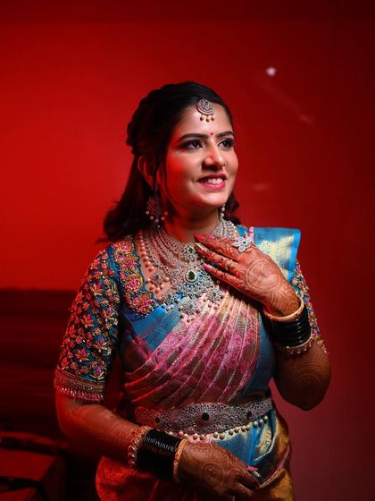 A dramatic shot with red lighting, showing how versatile the makeup is. It remains flawless and striking even under creative lighting conditions.