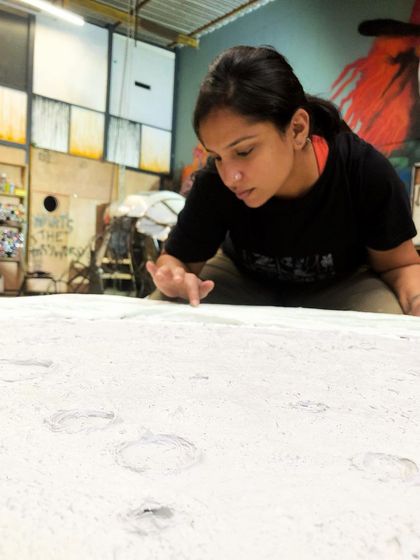 A photo of me at work on the moon sculpture. The process of creating the craters and textures by hand was incredibly satisfying and meditative.