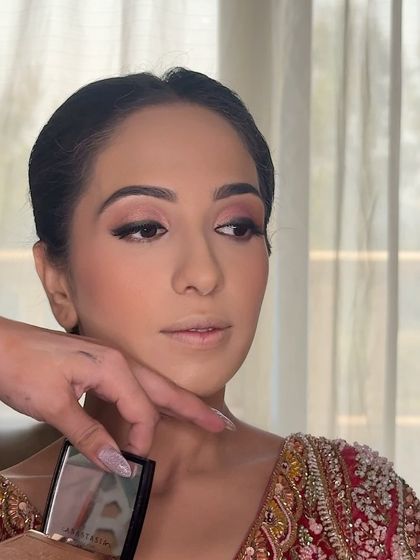 Contouring and highlighting are key to enhancing features. Here, I'm applying a soft highlighter to the high points of the face for a subtle, beautiful glow.