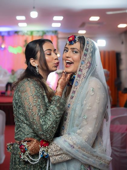 A fun and loving moment between the bride and her sister or friend during the Mehendi ceremony. I capture the bonds and relationships that make the day special.