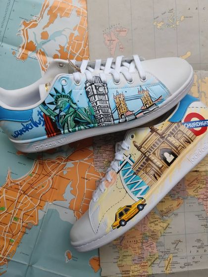Another shot of the travel-themed custom sneakers, laid out on a vintage map.