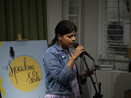 A young artist confidently shares her work at our open mic.