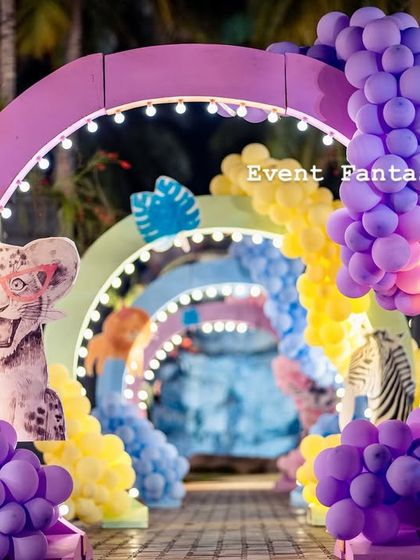 A vibrant, rainbow-colored balloon archway entrance for the "Party Animal" themed birthday bash, inviting guests into a world of fun.