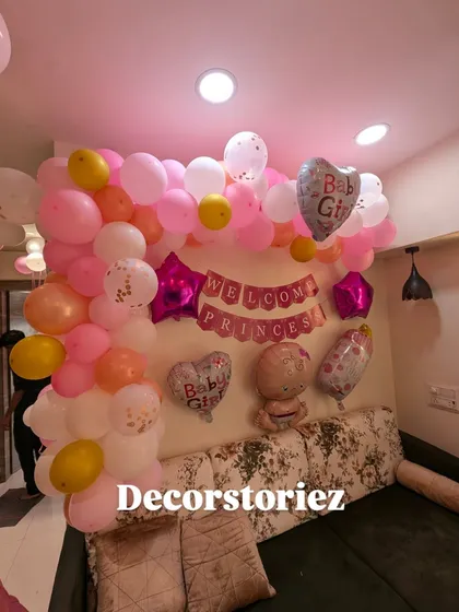 A close-up of the balloon wall for a "Welcome Princess" theme. We used a mix of pink, white, and gold balloons, along with star and baby-themed foil balloons, to create a festive photo corner.