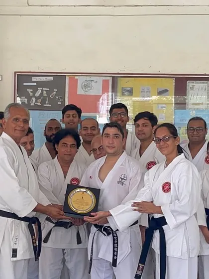Kyoshi Sensei presents a plaque to Sensei Kaivan Fatakia, a former National Champion, thanking him for his invaluable guidance during a tournament preparation seminar for our senior students.
