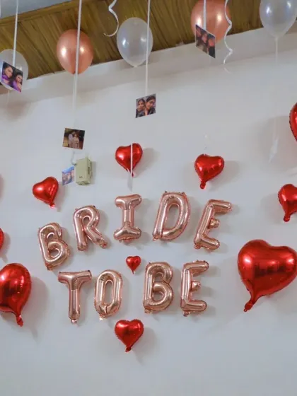 This image shows the details of the hanging photos and balloons, creating a personalized touch for the bridal shower.