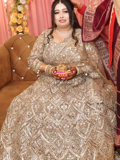 The bride holding a decorative piece, a candid shot that captures the festive atmosphere of the engagement.