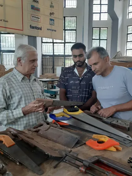 An instructor discusses the different types of handsaws with students, explaining the purpose of each and demonstrating the proper techniques for use.